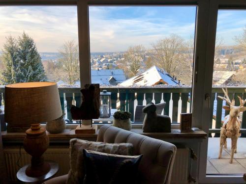 a living room with a window with figurines of animals at HOME Suites Maisonette mit Sauna in Braunlage