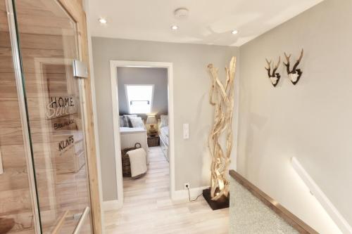 a hallway with a walk in shower and a room with at HOME Suites Maisonette mit Sauna in Braunlage