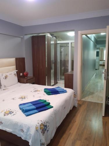 a bedroom with a bed with blue towels on it at Bedir Comfortable Apartment 120m to Taksim Square in Istanbul