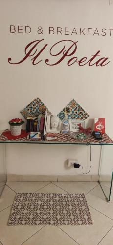 a counter with a table with a bed and breakfast sign on it at B&B IL POETA in Palermo