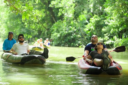 a group of people riding on rafts in a river at Khao Sok River Lodge Hotel in Khao Sok