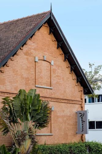 a brick building with a sign on the side of it at Radisson Hotel Tamboho Waterfront Antananarivo in Antananarivo