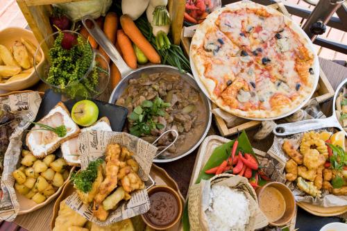 a table topped with lots of different types of food at Radisson Hotel Tamboho Waterfront Antananarivo in Antananarivo