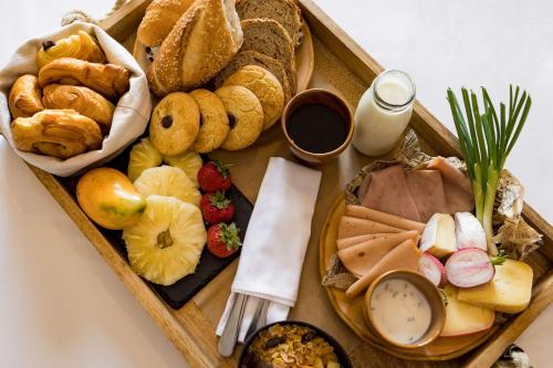 a tray filled with different types of bread and pastries at Radisson Hotel Tamboho Waterfront Antananarivo in Antananarivo