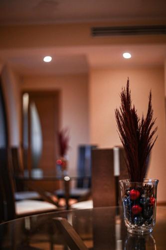 a glass vase with a plant on a table at Castello di Pandora in Nepi
