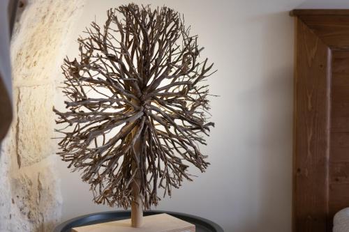 a sculpture of a tree sitting on a table at Trulli in Vigna in Selva di Fasano