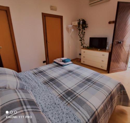 a bedroom with a bed and a dresser and a tv at La Casetta Mini Appartamento Centro Storico in Reggio di Calabria