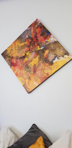 a close up of a painting on a wall at La petite maison in Le Bosc-Roger-en-Roumois