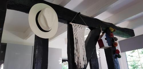 a hat and some clothes hanging from a window at La petite maison in Le Bosc-Roger-en-Roumois