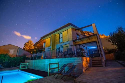 a house with a swimming pool at night at Halte Air et Go in Marcoux