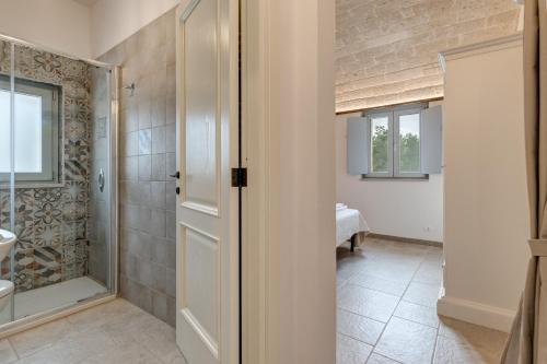 a bathroom with a shower and a sink at Trulli in Vigna in Selva di Fasano