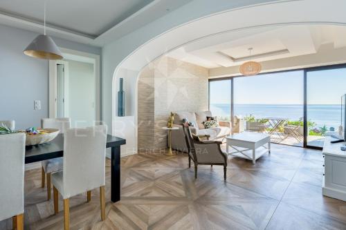 a kitchen and living room with a view of the ocean at ADRIANA by Terry's Homes WATERFRONT SEAVIEW BEACH in Cannes