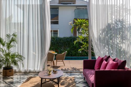 a living room with a couch and a table at La Maroma 3 BHK Splendid Villas in Anjuna - Pvt Pool- Garden & Caretaker in Vagator