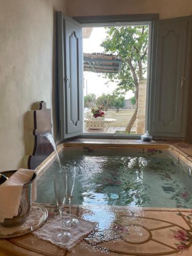 a pool of water with a window and a fountain at Tenuta Mosè Charming House&Relais Gallipoli in Gallipoli