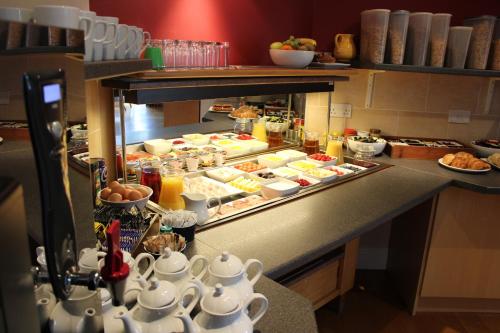 a kitchen with a buffet of food on a counter at Brathay Lodge in Ambleside