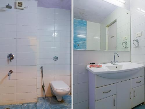 a bathroom with a sink and a toilet at The Byke Sunshine Grand in Ooty