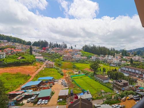 an aerial view of a city with buildings at The Byke Sunshine Grand in Ooty