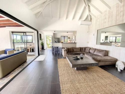 a living room with a couch and a table at Villa Zen, luxury and confort, private pool and sea view in Cul de Sac