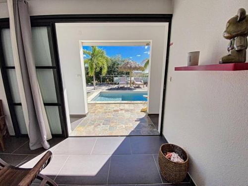 a hallway with a door leading to a swimming pool at Villa Zen, luxury and confort, private pool and sea view in Cul de Sac