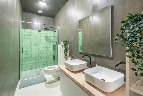 a bathroom with a sink and a toilet and a shower at Antwerps Central Residence in Antwerp