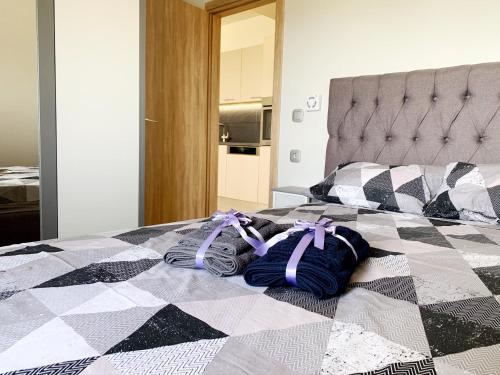 a bed with purple bows on top of it at Yamina Sea View Residence in Agia Pelagia