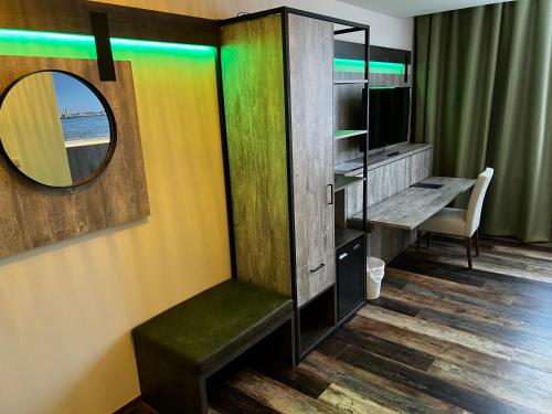 a room with a mirror and a chair and a desk at Hotel Nap in West-Terschelling