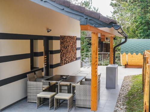 a pergola with a table and chairs on a patio at Ferienhaus in Niederösterreich mit 3 Apartments mitten im Wald in Feichtenbach