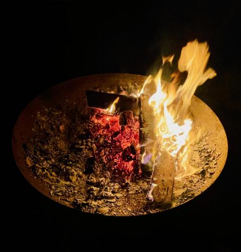 a piece of cake is on fire in a plate at Die Strumpffabrik - Guesthouse in Kerpen