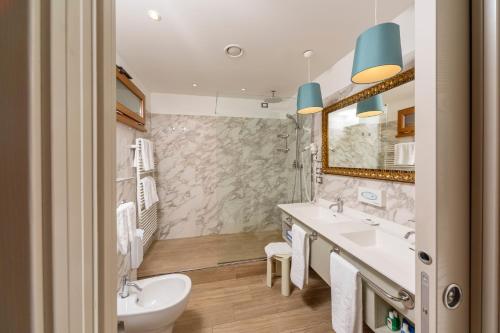 a bathroom with a sink and a toilet at Hotel Porto Roca in Monterosso al Mare
