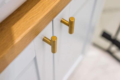 a close up of drawer pulls on a white cabinet at Apartament KASHMIR in Gdańsk