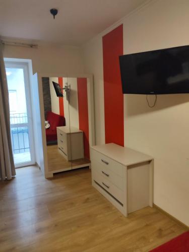 a room with a dresser and a tv on a wall at Apartment in the center of Krakow in Kraków