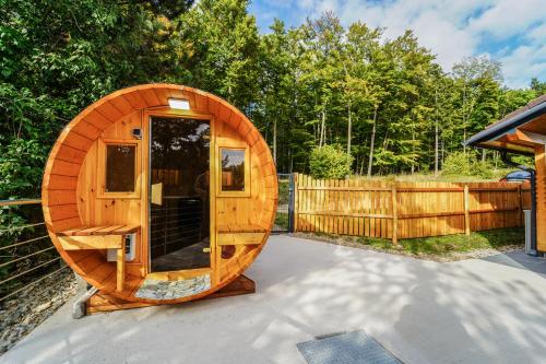 a wooden circular cabin with a wooden fence at Ferienhaus in Niederösterreich mit 3 Apartments mitten im Wald in Feichtenbach