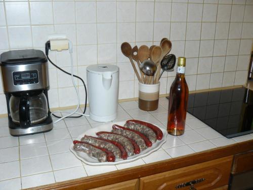 a group of sausages on a plate on a kitchen counter at Maison Charentaise in Les Essards