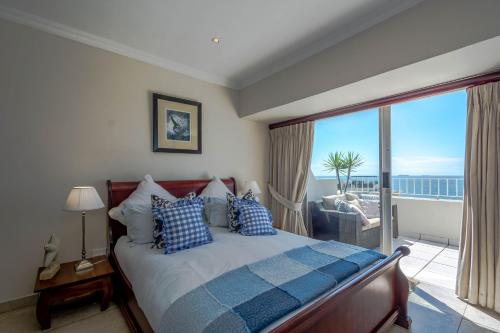 a bedroom with a bed with a view of the ocean at 305 Ben Siesta in Durban