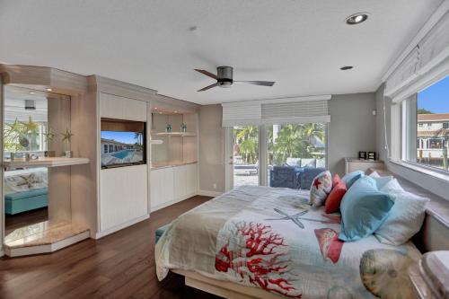 a bedroom with a large bed and a large window at Palms by the Sea Villa in Fort Lauderdale