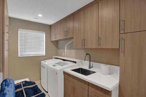 a kitchen with a washing machine and a sink at Palms by the Sea Villa in Fort Lauderdale