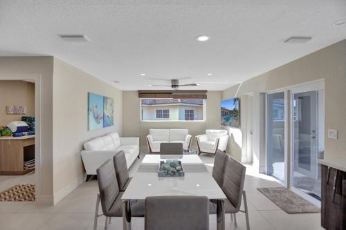 a dining room and living room with a table and chairs at Palms by the Sea Villa in Fort Lauderdale