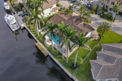 an overhead view of a house with palm trees next to the water at Palms by the Sea Villa in Fort Lauderdale