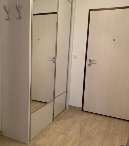 a room with two glass doors and a mirror at Apartman 2 Old Bridge view in Mostar