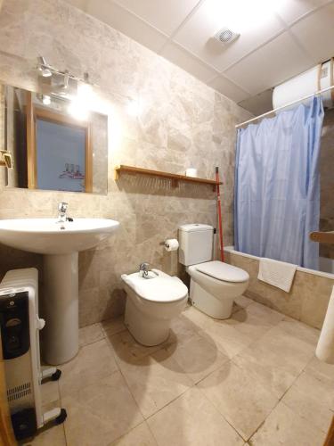 a bathroom with a toilet and a sink at Loft Miramar in Sierra Nevada
