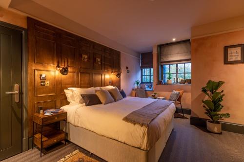 a bedroom with a large bed and a window at The Wolfpack Inn in London