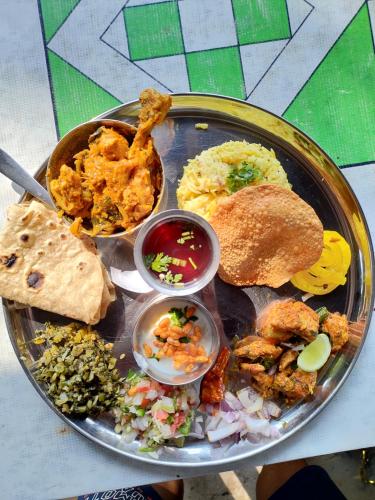 a plate of food with different types of food on it at Secret Garden Arambol in Arambol