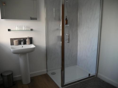 a bathroom with a shower and a sink at The Fox and Hounds in Whittlebury