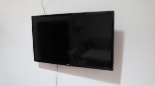 a flat screen tv hanging on a wall at Apartamento Corral de Triana in Seville