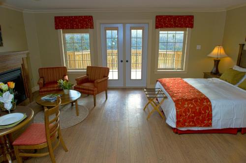a bedroom with a bed and a living room at The Wilds at Salmonier River in Holyrood
