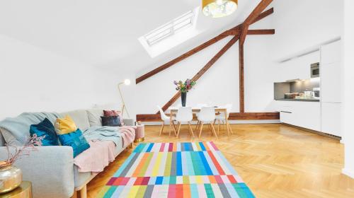 a living room with a couch and a colorful rug at Residence Dlouha - Old Town in Prague