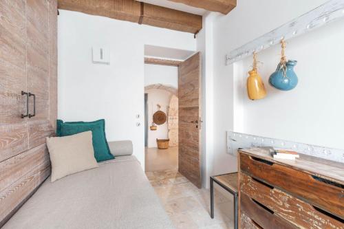 a bedroom with a bed and a wooden wall at Trullo Atena in Alberobello