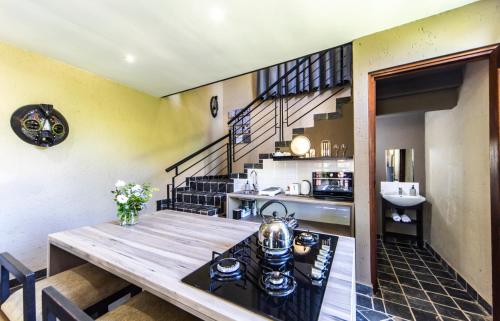 a kitchen and dining room with a table with a tea kettle at Craigivar Guesthouse in Pretoria