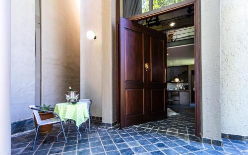 a table and chairs sitting next to a door at Craigivar Guesthouse in Pretoria