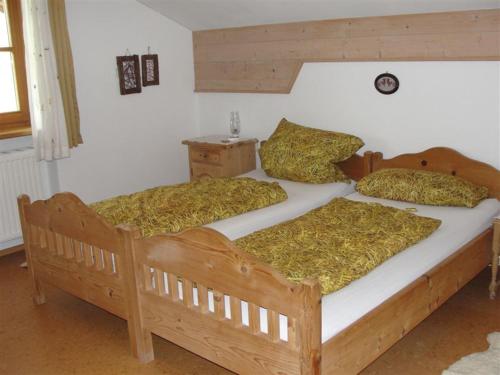 two wooden beds in a room with at Wagner-Schneider-Hof in Chieming